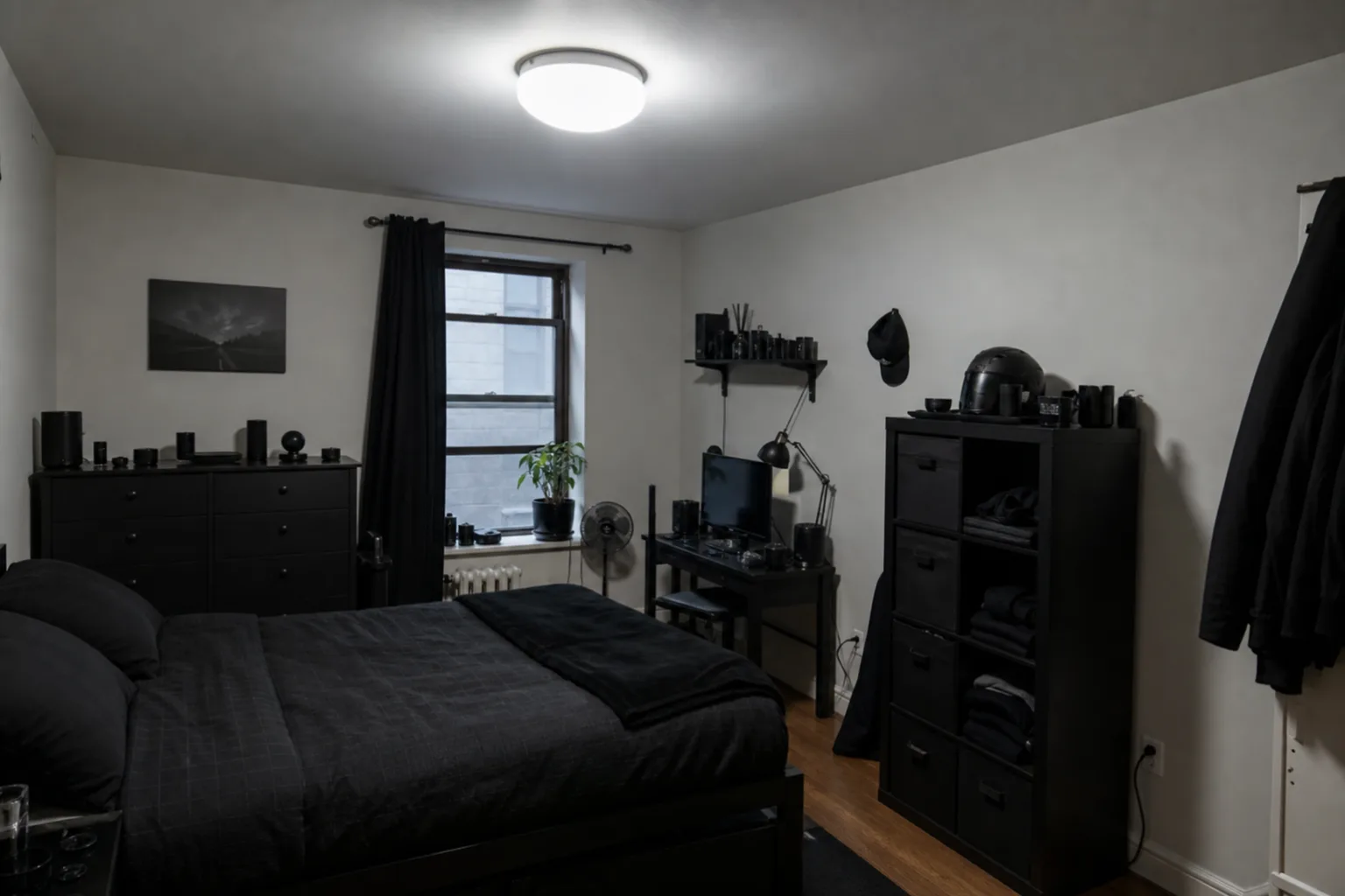 Small bedroom overwhelmed by many dark objects and one harsh ceiling light